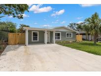 Inviting single-story home featuring a covered entry and a spacious driveway at 6620 Del Prado Ter, New Port Richey, FL 34652