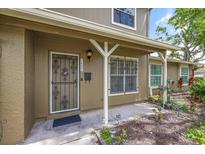 Charming home entrance with decorative security door and well-maintained landscaping at 7627 Deleon Ct, Tampa, FL 33615