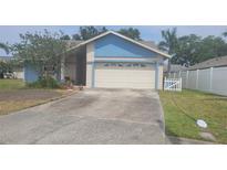 Charming single Gathering home featuring attached two car garage and well manicured lawn at 12125 71St Way, Largo, FL 33773