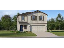 Charming two-story home featuring a two-car garage, well-manicured lawn, and inviting blue front door at 2278 Blue Grosbeak Pl, Wimauma, FL 33598
