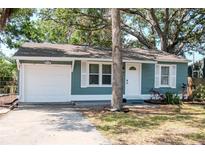 Charming single Gathering home with white trim, light blue siding and an attached garage at 2616 47Th N Ave, St Petersburg, FL 33714