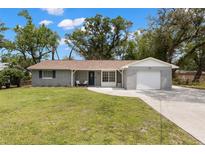 Charming single-story home with a brick facade, well-maintained lawn, and attached one car garage at 3119 W North St, Tampa, FL 33614