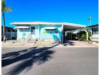 Charming, well-maintained mobile home featuring a covered carport and tasteful decor, perfect for coastal living at 34483 Cactus N Dr, Pinellas Park, FL 33781