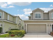 Inviting two-story home with an attached two-car garage and well-maintained front yard at 513 Harbor Springs Dr, Palm Harbor, FL 34683