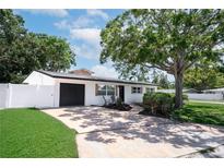 Charming single-story home with a well-maintained lawn, mature tree, and a one-car garage at 5698 26Th N Ave, St Petersburg, FL 33710