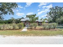 Charming single-story home with a metal roof and well-maintained front yard at 6118 Kracker Ave, Gibsonton, FL 33534