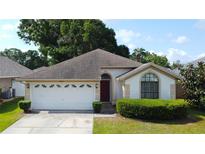 Charming single-story home with a well-manicured lawn and a two-car garage at 8812 Beeler Dr, Tampa, FL 33626