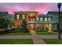 Charming two-story townhome with brick facade, balcony and lush landscaping at 10035 New Parke Rd, Tampa, FL 33626
