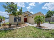 Charming single-story home with a well-manicured lawn and inviting curb appeal at 14614 Rannoch Moor Pl, Wimauma, FL 33598