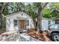 Charming single-story home with mature trees, a walkway, and a nicely landscaped yard at 1608 E Linden Ave, Tampa, FL 33604