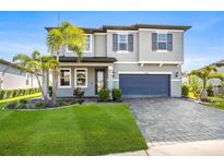 Beautiful two-story home with a well-maintained lawn and a paved driveway leading to a two-car garage at 34307 Radley Way, Wesley Chapel, FL 33545