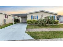 Charming single-story home featuring a carport, garage, and well-maintained landscaping at 520 Canal Way, Oldsmar, FL 34677