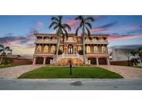 Elegant multi-story home with a grand entrance staircase and multiple balconies at 5810 Mariner St, Tampa, FL 33609