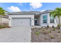 Charming single-story home boasts a gray tiled roof, two car garage, and attractive landscaping at 7610 Addison Ave, Bradenton, FL 34210