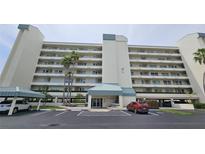 Multi-story condo building with covered parking and palm trees in a well maintained landscape at 7922 Sailboat Key S Blvd # 608, South Pasadena, FL 33707
