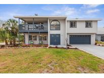 Charming two-story home boasting a well-manicured lawn, upper porch, and an attached two car garage at 824 35Th Avenue W Dr, Palmetto, FL 34221