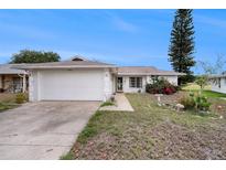 Charming single story home with attached garage and well-kept landscaping in a quiet neighborhood at 8305 Palencia Dr, Port Richey, FL 34668