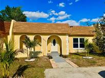 Charming single-story home with a well-maintained front yard and beautiful blue skies at 9893 86Th N Way, Seminole, FL 33777