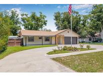 Inviting single-story home featuring a large driveway and manicured front yard at 9981 58Th N St, Pinellas Park, FL 33782