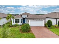 Beautiful single-story home with a two-car garage and a well-manicured front yard at 19877 Sea Glass Cir, Land O Lakes, FL 34638