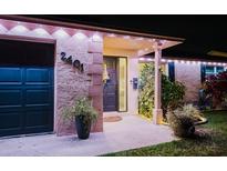 Charming home exterior at night with inviting entrance, stylish accents, and well-lit landscaping at 2401 66Th S Ave, St Petersburg, FL 33712