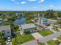 An aerial view captures the home's location on a waterfront canal, showcasing the property's access to waterways at 261 Kentucky Ave, Crystal Beach, FL 34681