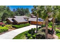 Stunning single-story home featuring mature landscaping, long driveway, and attached two car garage at 29903 Baywood Ln, Wesley Chapel, FL 33543