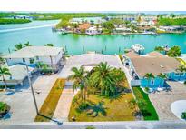Stunning waterfront home with a private dock and lush tropical landscaping at 365 La Hacienda Dr, Indian Rocks Beach, FL 33785