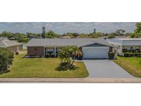 Charming single-story home featuring a well-manicured lawn and two car garage at 4014 Pleasant Ridge Dr, New Port Richey, FL 34652