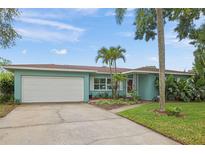 Charming single-story home featuring a well-maintained lawn, and lush landscaping for enhanced curb appeal at 811 Woodley Rd, Clearwater, FL 33764