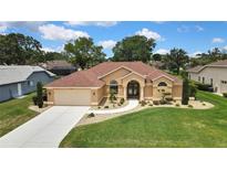 Beautiful single-story home featuring lush landscaping and a welcoming entrance at 9346 Southern Belle Dr, Weeki Wachee, FL 34613