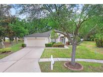 Charming one-story home featuring a well-manicured lawn and a two-car garage at 1934 Samantha Ln, Valrico, FL 33594
