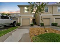 Inviting townhome featuring a one car garage, neutral paint and well maintained landscaping at 2129 Lennox Dale Ln, Brandon, FL 33510