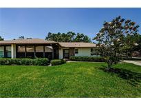 Charming home with mature tree, inviting screened-in porch and a well-manicured lawn at 368 Perth Ct # 368, Dunedin, FL 34698