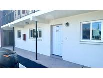 Low-rise apartment building with a white exterior and visible unit number 167, showing windows and door at 4560 Overlook Ne Dr # 167, St Petersburg, FL 33703