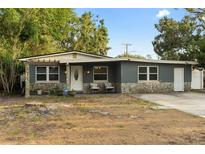 Charming single-story home with stone accents, neutral paint, well-maintained landscaping, and a welcoming front entrance at 8001 N Ola Ave, Tampa, FL 33604