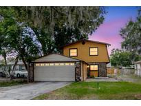 Charming two-story home with a two-car garage and a well-maintained lawn at 1010 Oakhill St, Seffner, FL 33584