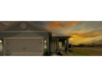 Charming single-Gathering home showcasing a well-manicured lawn and an attached two-car garage at 10153 Spruce River Way, Parrish, FL 34219