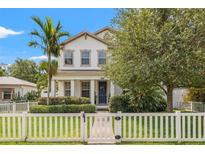 Charming two-story home featuring a white picket fence, manicured landscaping, and a welcoming front entrance at 1436 30Th N Ave, St Petersburg, FL 33704