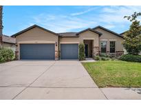 Charming single-story home featuring a three-car garage and beautifully landscaped front yard at 1512 Banner Elk St, Valrico, FL 33594