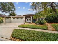 Charming single-story home with a well-manicured front yard, arched entry, and a convenient two-car garage at 160 Sage Cir, Crystal Beach, FL 34681