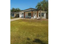 Charming single-story home featuring a well-manicured lawn and inviting front porch at 1778 New Hampshire Ne Ave, St Petersburg, FL 33703