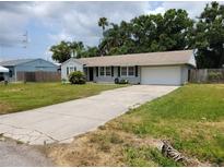 Charming single-story home featuring a well-manicured lawn and a private two-car garage at 2701 47Th N Ave, St Petersburg, FL 33714