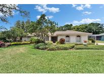 Charming single-story home with lush landscaping and a well-maintained lawn at 2811 Barret Ave, Plant City, FL 33566