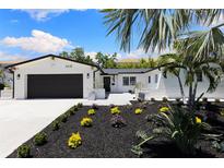 Charming painted brick home with modern landscaping and a two-car garage at 4618 Bayshore Ne Blvd, St Petersburg, FL 33703