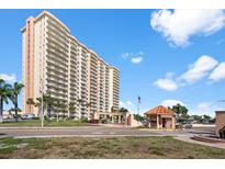 Beautiful high-rise condo with multiple balconies and a secured entry gate on a sunny day at 4900 Brittany S Dr # 209, St Petersburg, FL 33715