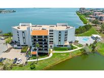 Stunning aerial view of the building with beautiful waterfront views and a refreshing pool at 5700 Escondida S Blvd # 401, St Petersburg, FL 33715