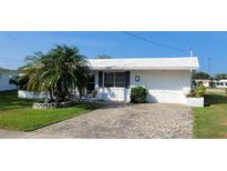 Charming single-story home featuring a brick driveway, attached garage, and well-maintained landscaping at 10040 38Th N Way, Pinellas Park, FL 33782