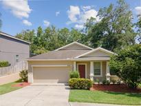 Charming single-story home featuring a well-maintained lawn and a two-car garage with neutral paint at 12212 Mcmullen Loop, Riverview, FL 33569