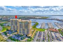 Stunning aerial view of luxury high-rise condos with marina and waterfront views at 140 Riviera Dunes Way # 1203, Palmetto, FL 34221
